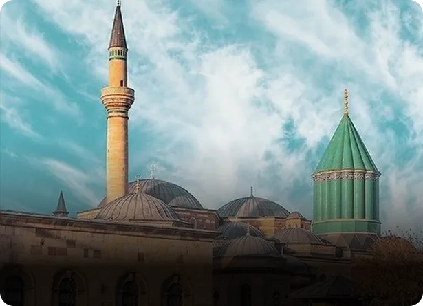 Mevlana Museum with its distinctive turquoise dome and minaret under a cloudy sky in Konya Turkey